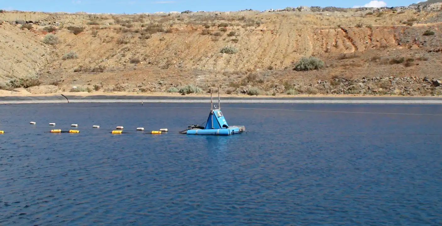The UAT dredge removing sediment from the process pond
